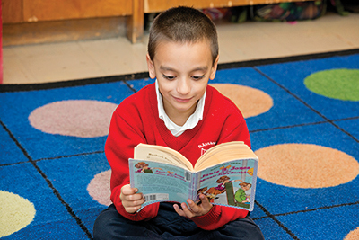 Boy reading at St. Ann's